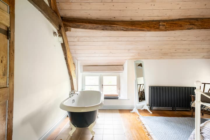 Roll top bath in the king bedroom