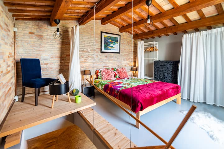 Qui ti sveglierai con il sorriso! Un mix giocoso di colori, legno e fascino: questa stanza trasmette un'atmosfera di vacanza e intimità.