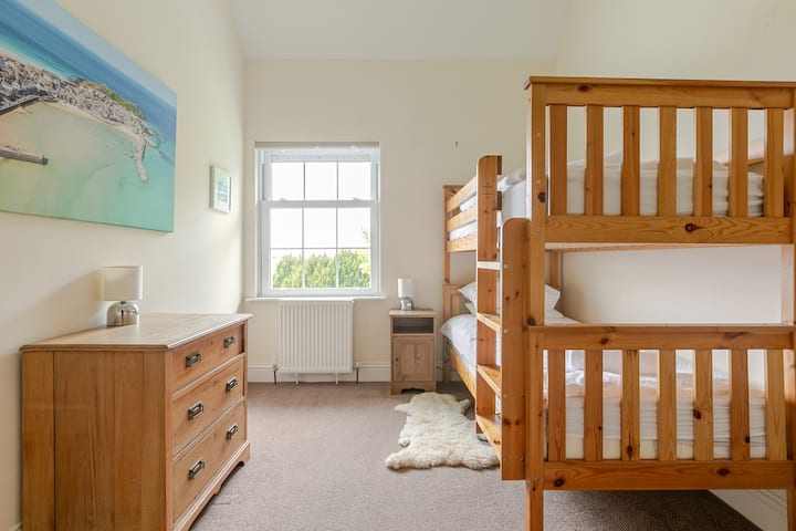Bunk beds in Bedroom 2, spring 2024. views across the field and estuary, to the hills at St Ives and Carbis Bay