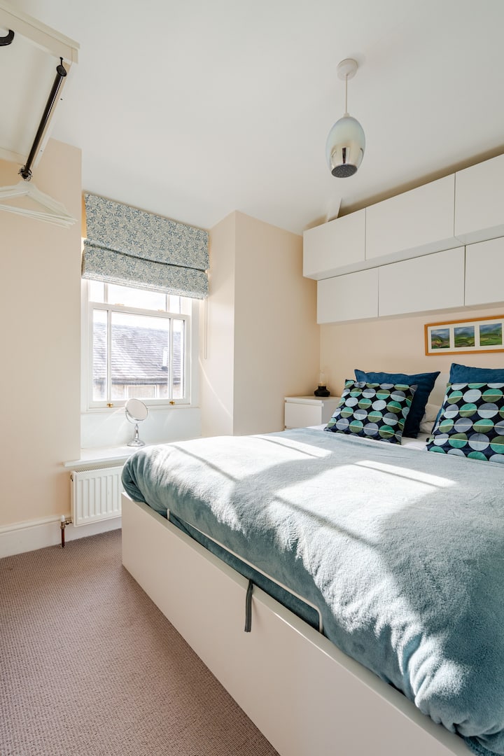 King Size bed with medium firm mattress, hanging space and bedside storage draws.