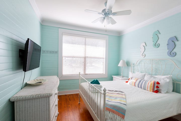 Queen bed, plenty of storage and a flatscreen TV in this seahorse inspired room.