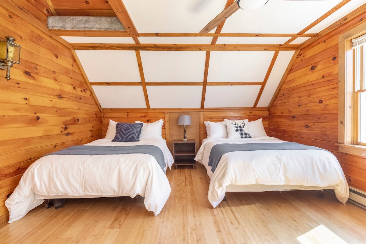 Upstairs bedroom 1 with two full beds, one twin bed, closet, and a desk with chair