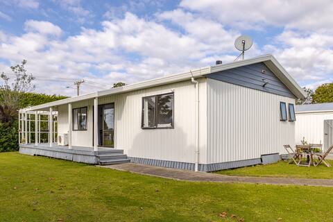 Seagull Cottage - a riverside bach near the beach.