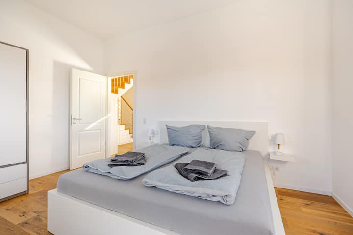 Second bedroom on the first floor with double bed, large wardrobe and access to the west balcony