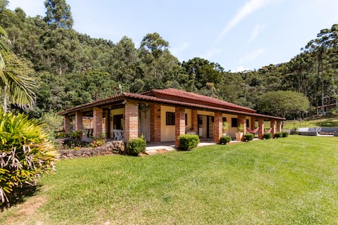 Beautiful pool house with sunbed and hot tub near waterfall