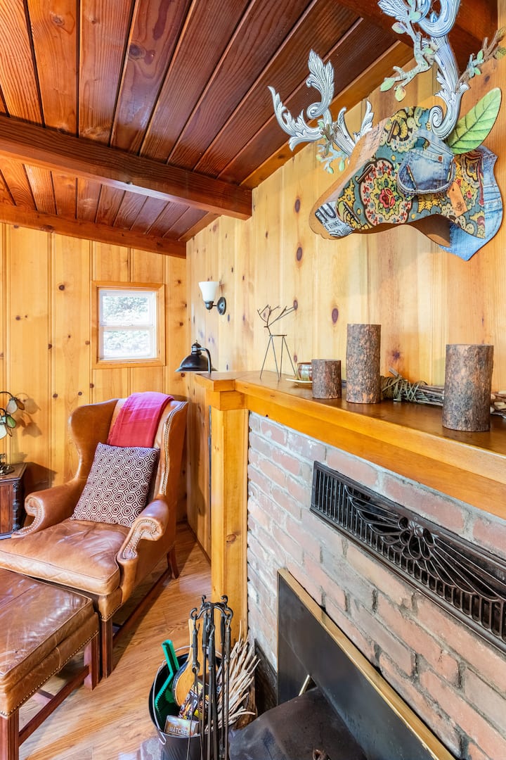 Moose, fireplace, and comfy leather chair