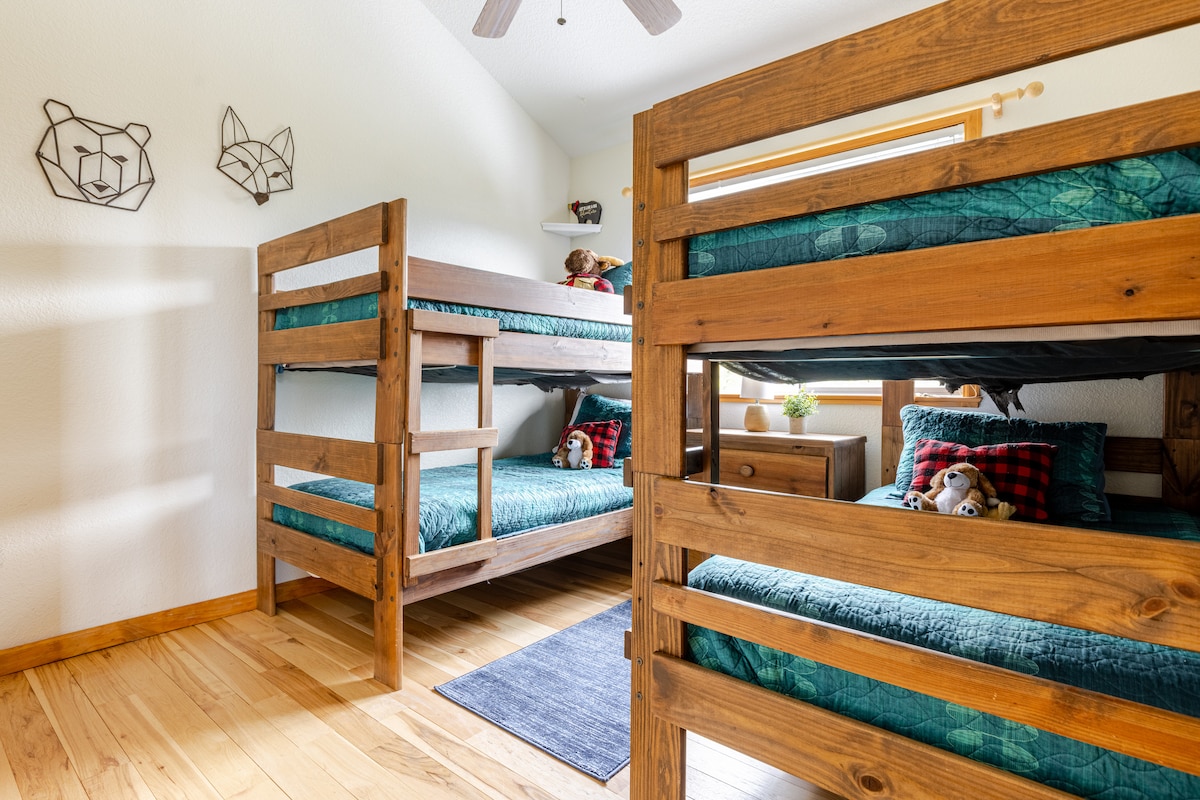 Here’s another view of the bunk bed room, highlighting the cozy setup with twin bunk beds and the charming stuffed forest animals that add a whimsical touch. 