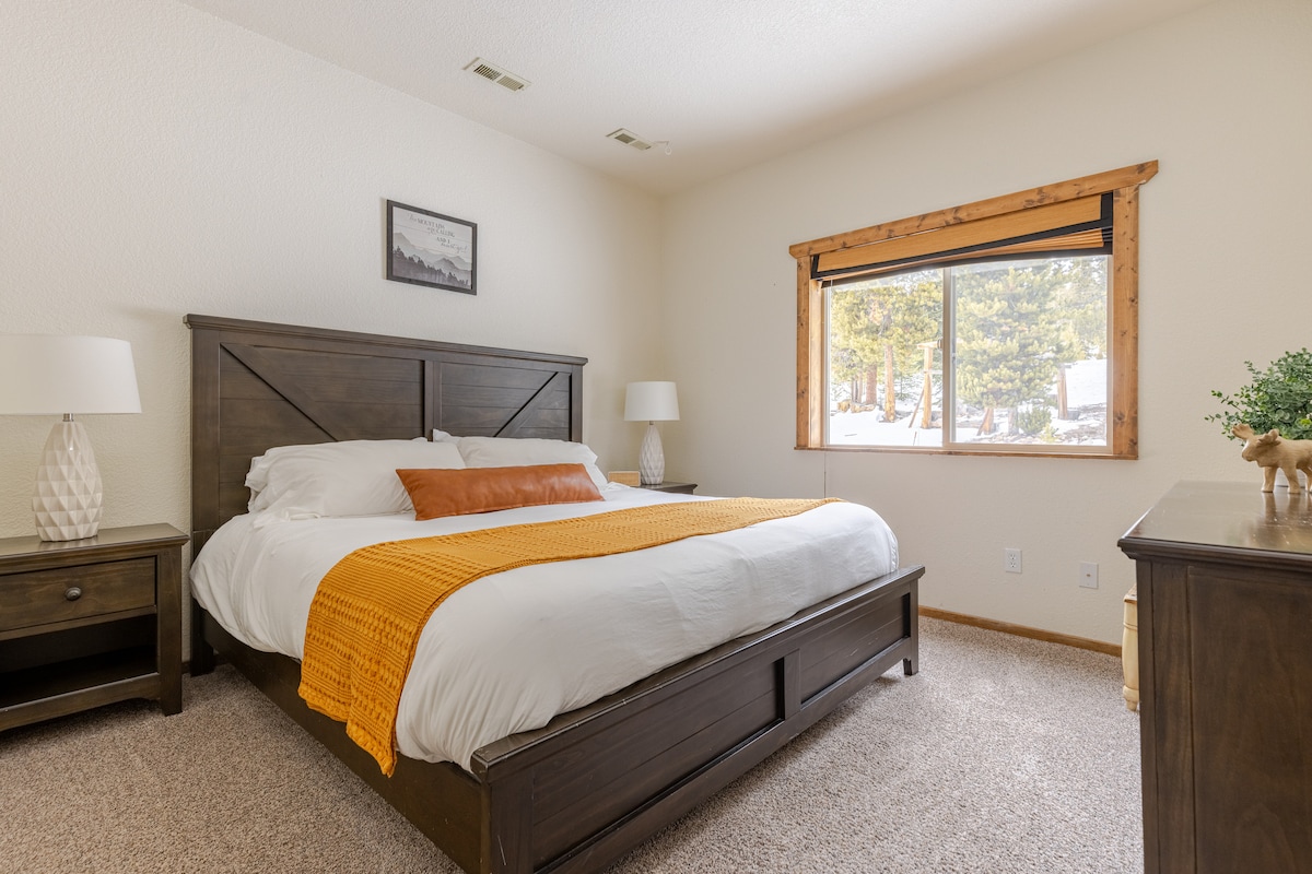 Here’s a glimpse of the downstairs master bedroom, featuring a cozy king-sized bed and a spacious layout. The lower-level bathroom is just steps away for your convenience, and we've also provided a space heater for added warmth whenever you need it!