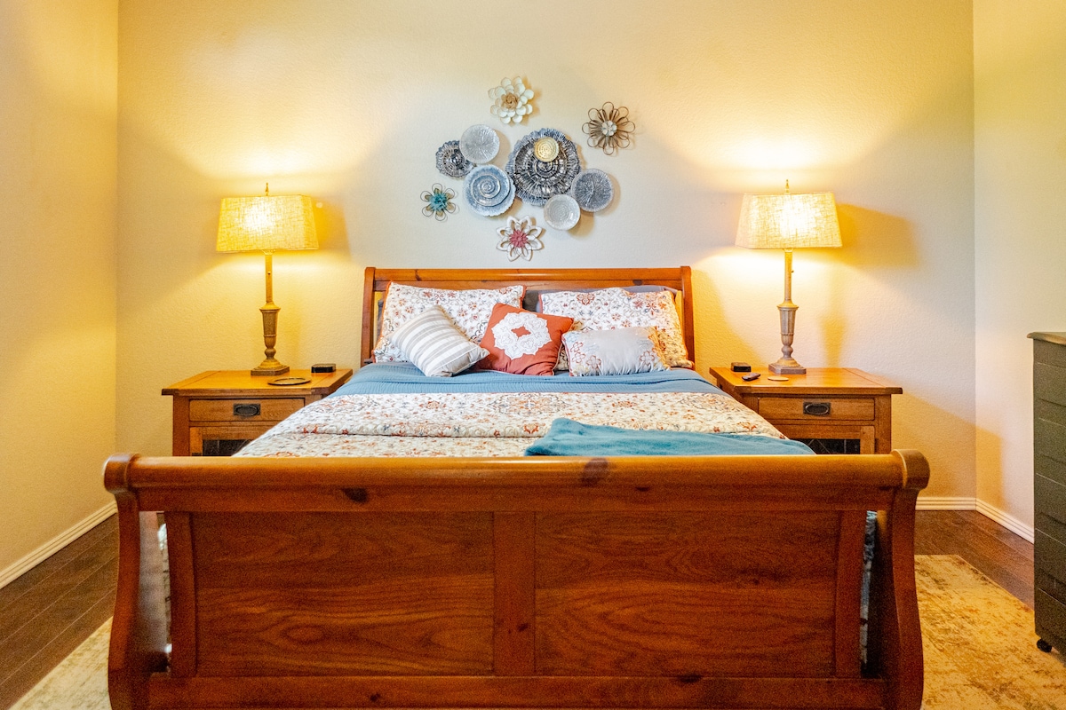 Amplio dormitorio principal, con TV inteligente de 50 pulgadas, portaequipajes, cajones de la cómoda, mesa de maquillaje, espejo de cuerpo entero y estación de carga USB en ambos lados de la cama. 