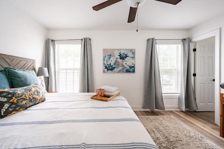 Bedroom 1 has a king bed, walk-in closet, attached full bathroom, a writing desk, and a Smart TV