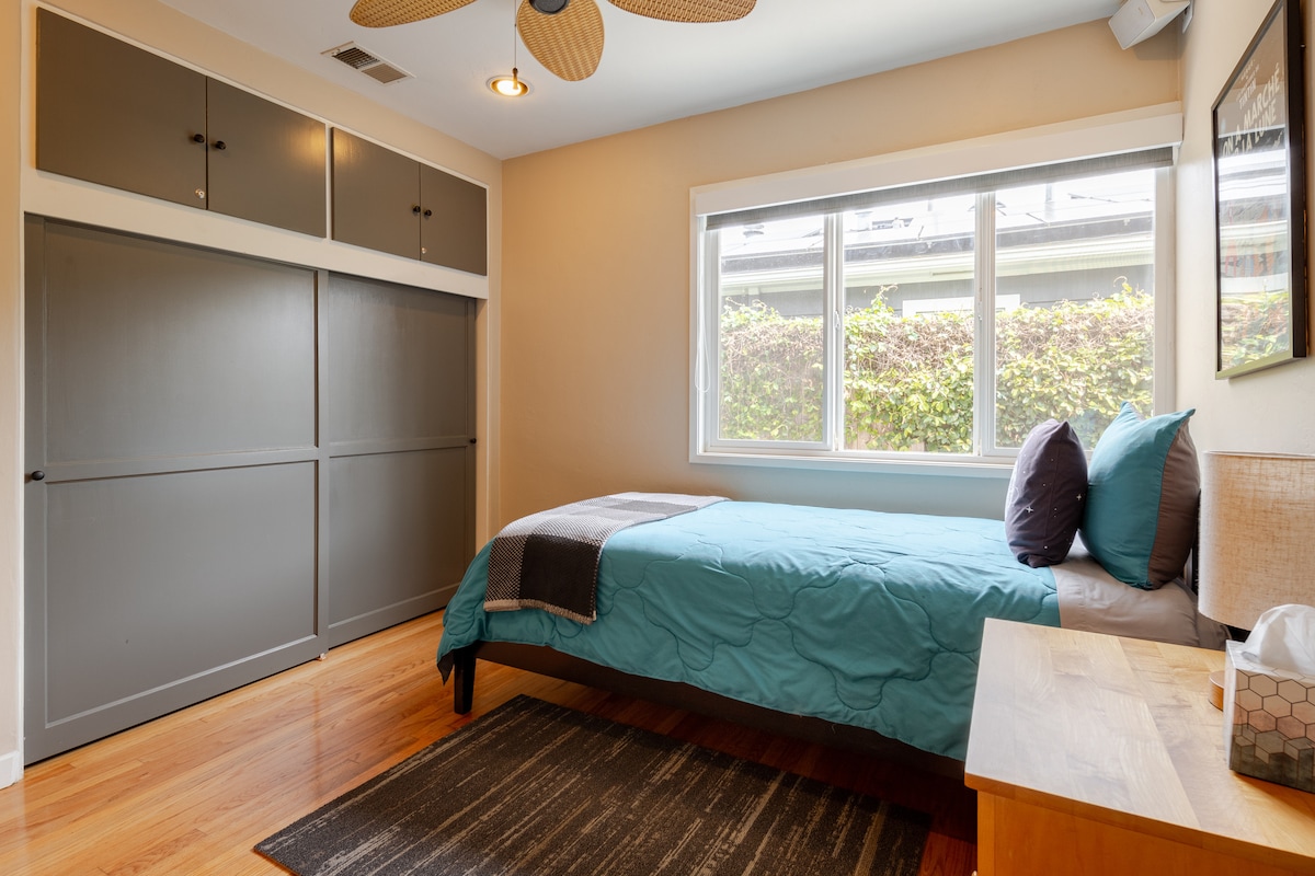 Bedroom 3: Twin-size bed. Blackout shade on the window. The left half of the closet is for guests' use and includes a printer.