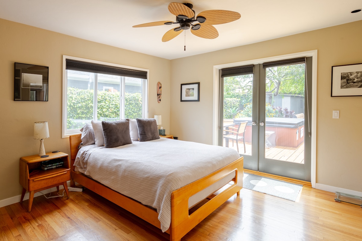 Bedroom 1: Master Bedroom, Queen Bed. Has a ceiling fan, and direct access to the backyard deck and private spa - a peaceful retreat for morning coffee or evening relaxation.