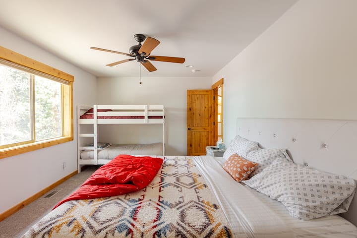 ห้องนอนชั้นบนมีเตียงคิงไซส์ที่สะดวกสบายเตียงสองชั้นที่อบอุ่นและสมาร์ททีวีขนาดใหญ่ที่รองรับผู้เข้าพักได้ 4 คนอย่างสะดวกสบาย ห้องพักกว้างขวางนี้เหมาะสำหรับครอบครัวหรือกลุ่มให้ความบันเทิงและสถานที่พักผ่อนที่ผ่อนคลายหลังการผจญภัยในทาโฮ