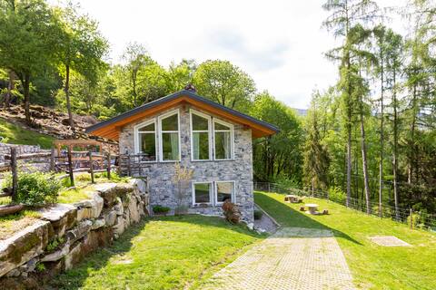 Stone cottage surrounded by greenery