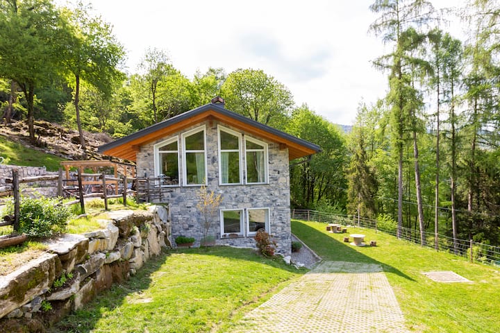 Stone cottage surrounded by greenery