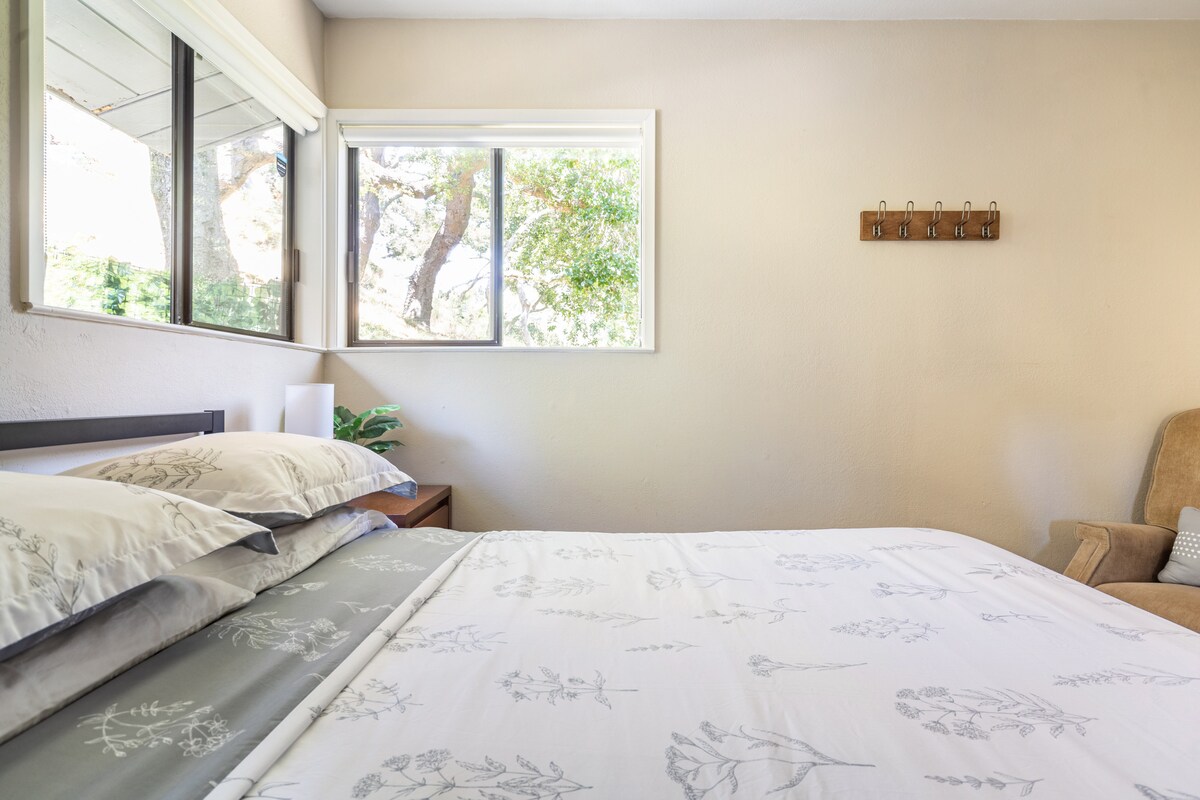 Bedroom with comfy Casper queen mattress, desk, chair (ergonomic chair available upon request), touch lamps with built-in chargers, standing anti-fatigue mat, and laptop stand.