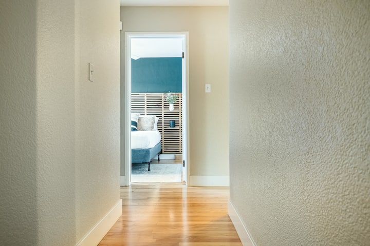 The cozy yet vibrant guest quarters channels an irreverent energy from its centerpiece: the locally handcrafted bed frame that seems almost sentient with its undulating wood grains.