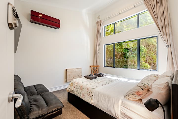 Bedroom 3 - Queen Bed. 4m ceilings. Air Con, 65” TV, Netflix-Prime-Disney-Apple-TV. Garden view. Tinted Windows. North Facing.  Double Wardrobe.