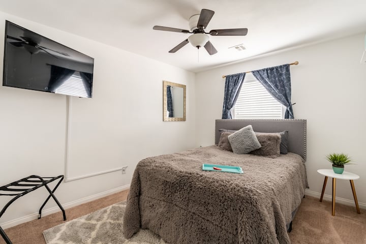 Queen bed with a Smart TV. Cast from your mobile device or watch from our YouTube TV service.