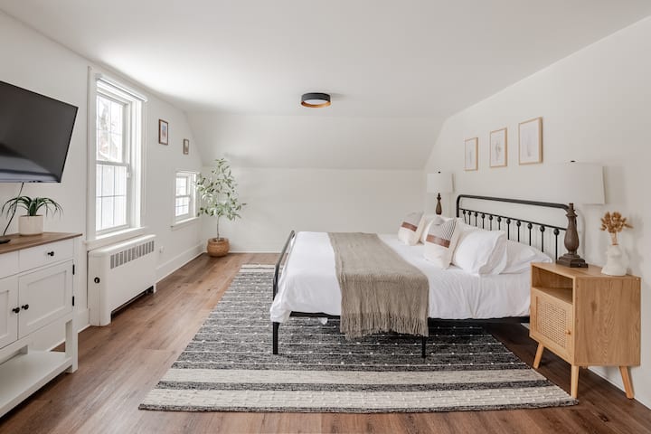 Upstairs King Loft complete with stunning property views, a sitting area, TV, and a king Purple Mattress, organic cotton sheets, orthopedic pillows + feather pillows, stunning views, and blackout blinds