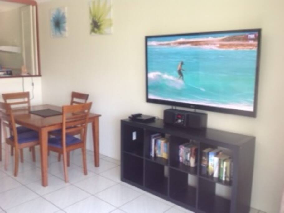 Living room with leather lounge massive TV Foxtel