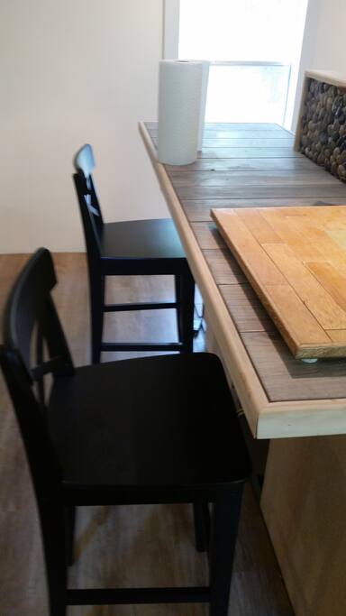 Bar with barstools up against the range Island