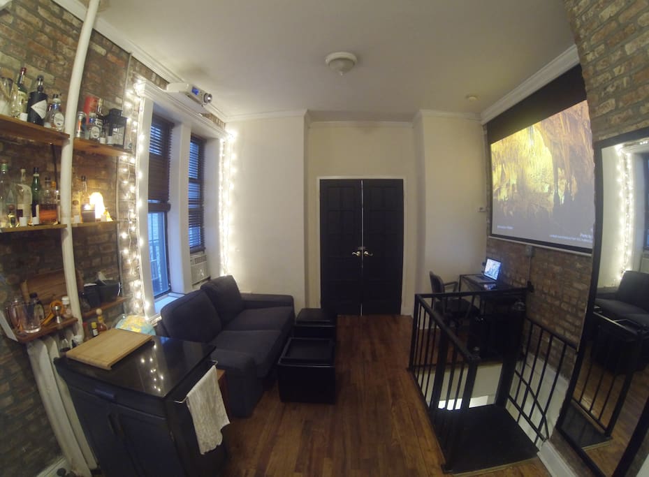 Upstairs living room with bar and movie theater.