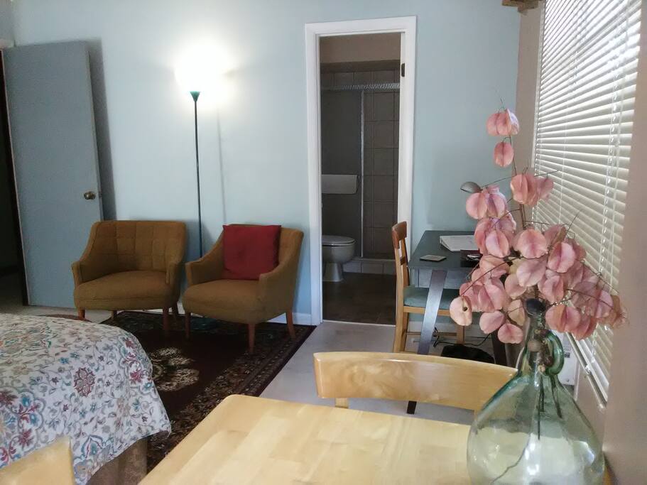 Seating area for two and ottoman with over head light, great for reading, relaxing, or taking your shoes off. Desk, computer work station (wifi) and ample lighting. New quiet air conditioning window unit with remote and fan, as well as, a ceiling fan.