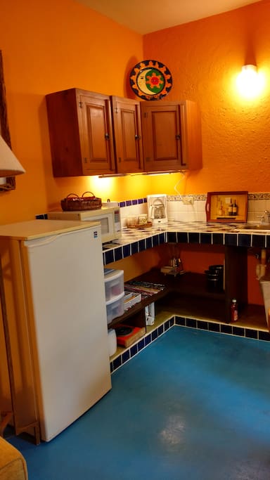 Kitchenette with grill/panini maker, toaster/confection oven, blender, mixer, and two burner hot plate. The kitchen is well-stocked with essentials.