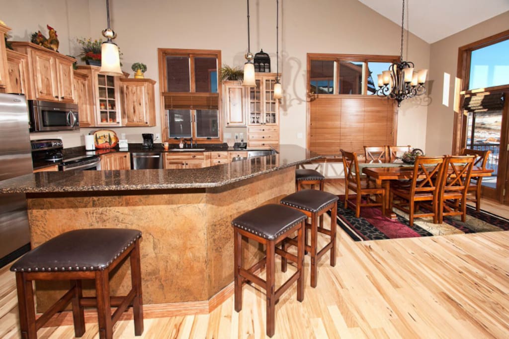 Main kitchen with granite counter tops and breakfast bar.