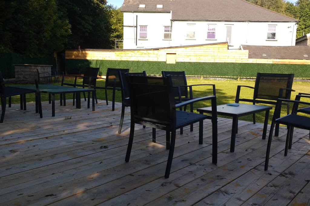 Large lawn with decking and BBQ area