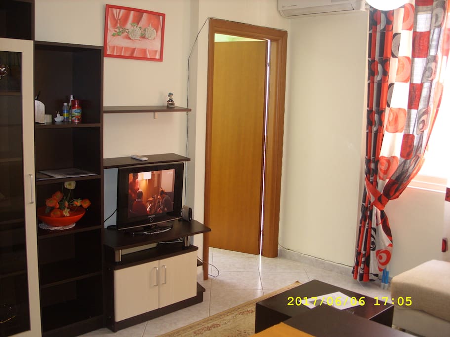 Kitchen and living room with cable TV and AC.