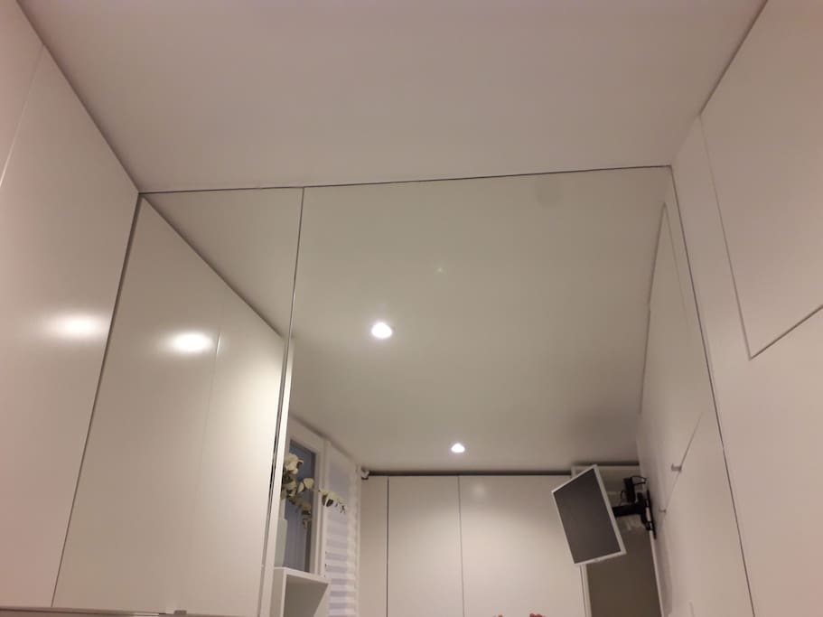 Minimalist view: closed cupboards, clean white walls and a large window