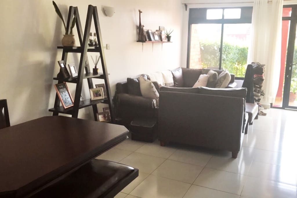 Main living room & dining area capable of seating 9 people comfortably. Modern bench style dining table and seats.