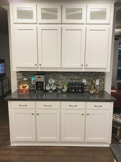 Kitchen Island and cabinets with amenities you might need.