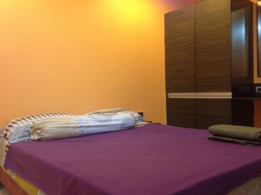 Comfy bedroom with queen-size bed, wardrobe, dressing table, AC, bed linens, towels
