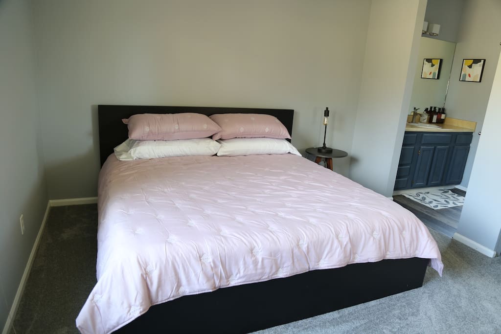 Master bedroom, king size bed, tons of drawers and closet with bathroom
