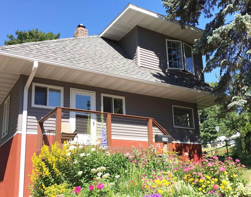 Our house is on a large corner lot with trees and gardens.