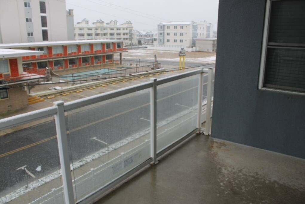 The balcony overlooks the pool and jacuzzi