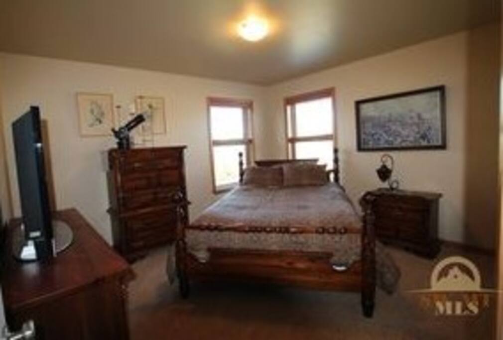 Bedroom with queen sized bed and closet.