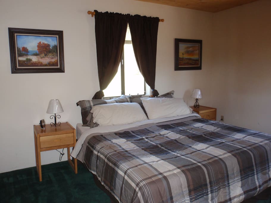 Upstairs bedroom with king-sized bed and shared bathroom