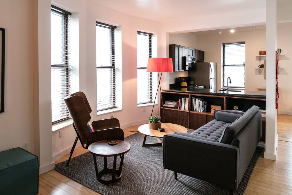 A mix of new and vintage furniture throughout the apartment.