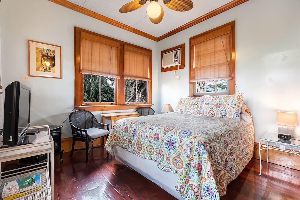 Bedroom with workspace and antique heart pine floors.
