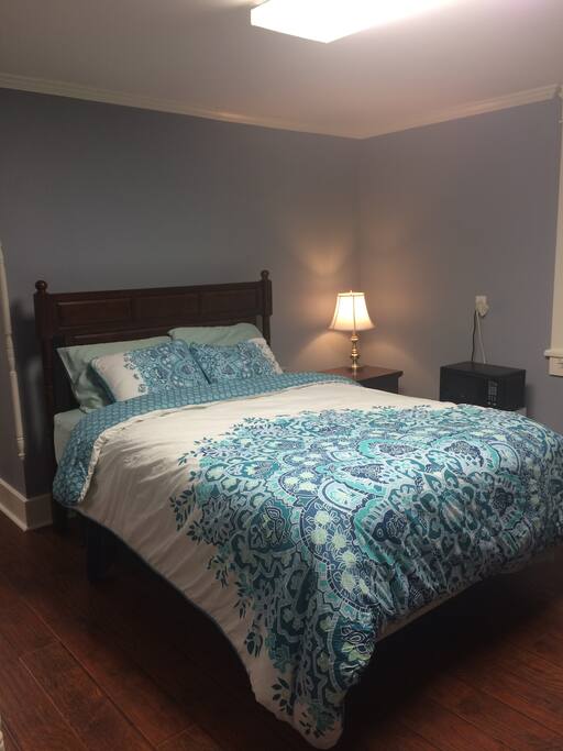 Queen-sized bed, mini fridge, coffee maker and microwave in room,