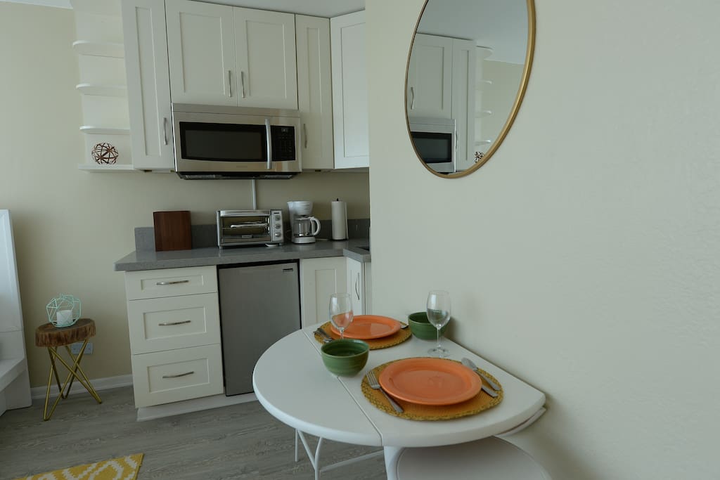 Kitchen with a 1 burner cook top fully equipped with pot and pans