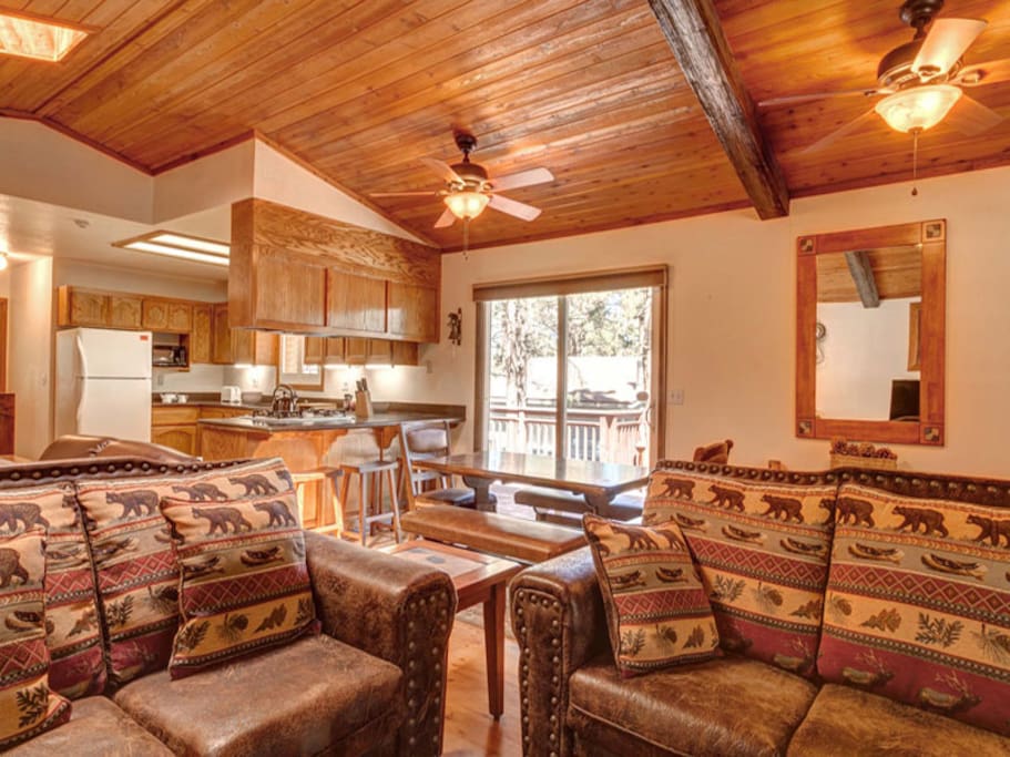 Spacious open living area with wood burning romantic fireplace, comfy sofa and LCD TV and WiFi.