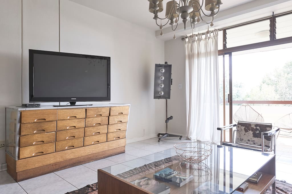 Large screen TV in lounge with assorted cable channels.