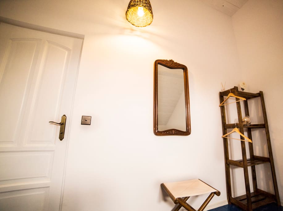 hand made wooden light pendant, reclaimed mirror and chair.