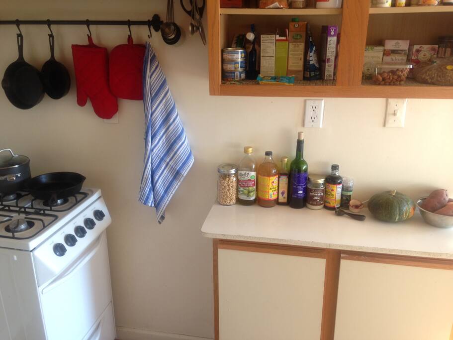Living room opens into fully-stocked small kitchen. Great place to cook.