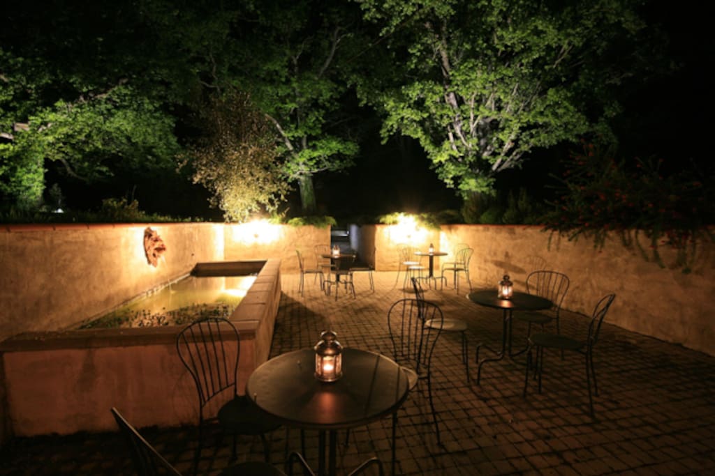 Courtyard area in garden with seating and lighting